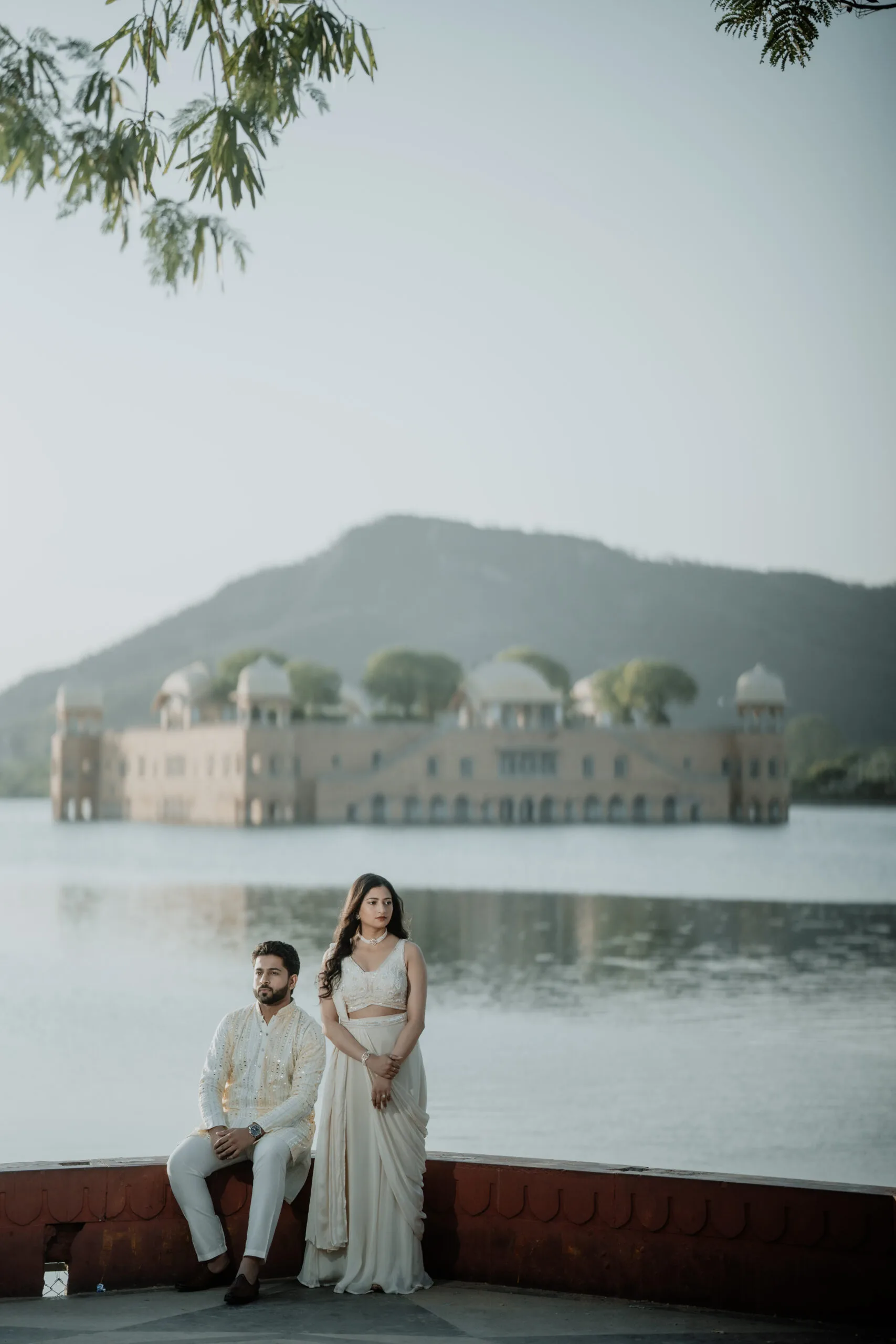 A couple in a saree and suit posing on white stairs for their Pre Wedding Shoot in jaipur.