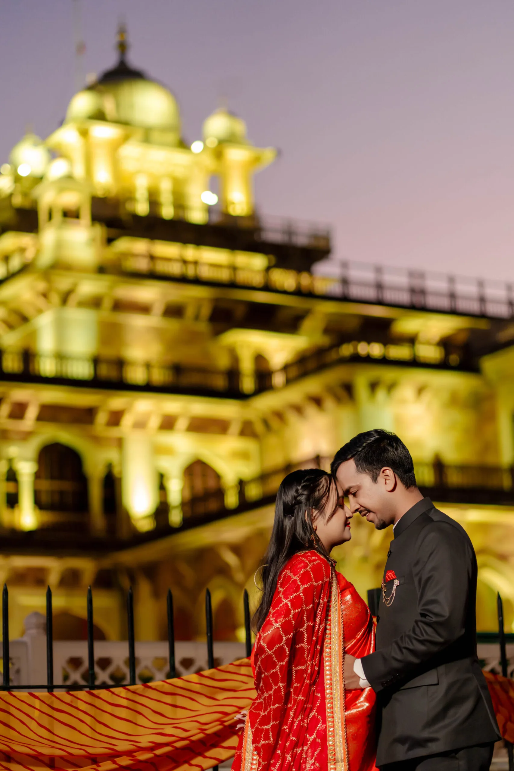A couple in a saree and suit posing on white stairs for their modern Pre Wedding Shoot in jaipur.