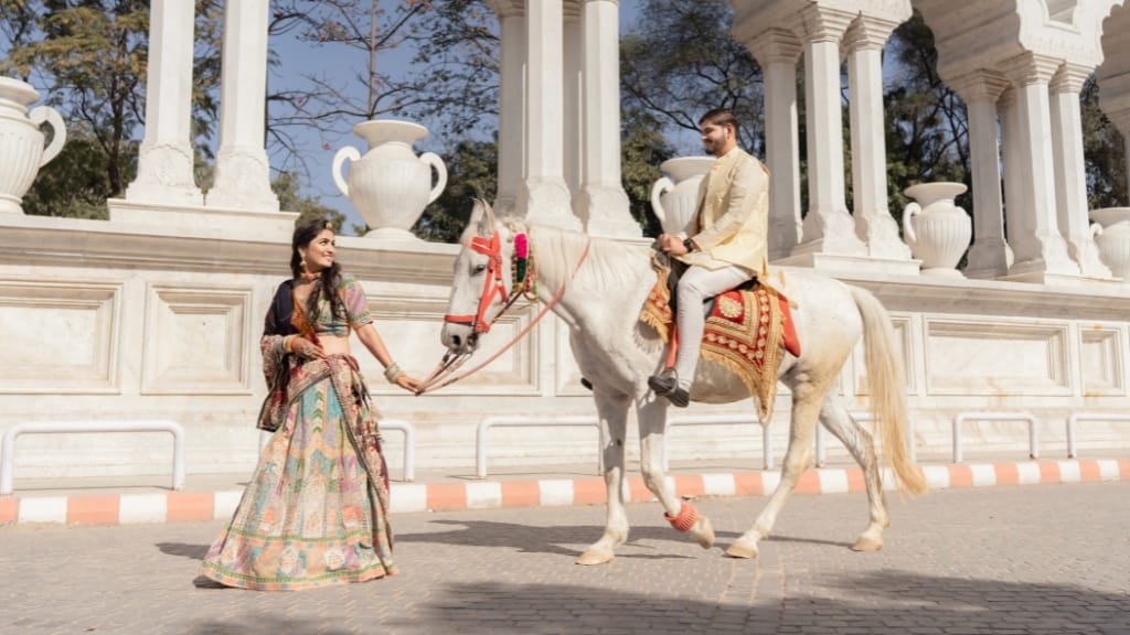 Royal couple photoshoot with a white horse at Toran Dwar, one of the elegant Pre Wedding Shoot Locations in Jaipur