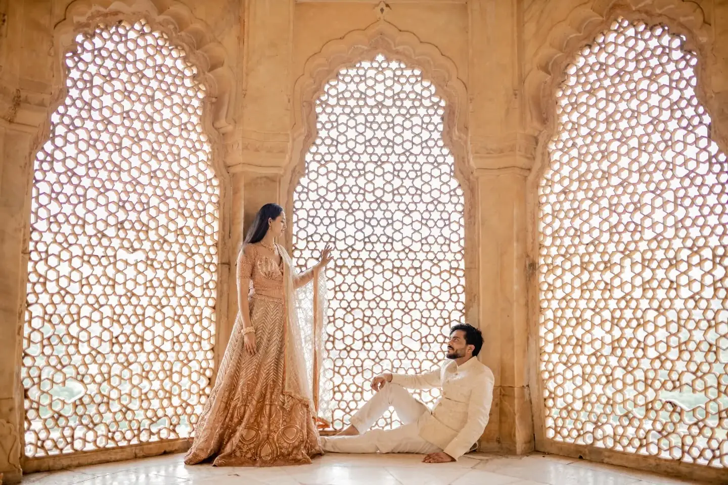 Couple at a sandstone jharokha during a pre wedding shoot in Jaipur